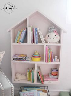 a doll house shelf with books and stuffed animals on it in a child's room