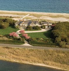 an aerial view of a large house near the ocean