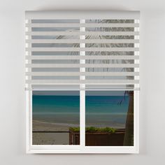 an open window with blinds on the beach and palm trees in the background, looking out onto the ocean