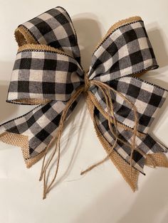 a black and white checkered bow tied to a wall