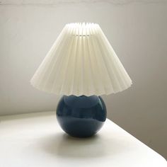 a blue lamp sitting on top of a white table