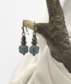 Beautiful Montana Blue Cathedral Bead Earrings. Small, dainty, petite earrings. Perfect for those who prefer small dangle earrings. Earrings are a total of one inch in length and .25 inches wide. Small but stunning! Handmade with an 8mm Czech glass cathedral bead. This bead is a beautiful Montana blue color with bronze finish on the top and bottom of the bead. Bronze accent beads, and a small dark blue fire polished crystal top it off.  Bronze ear wires and hooks. Each pair of my earrings comes Elegant Light Blue Beaded Dangle Earrings, Elegant Light Blue Beaded Drop Earrings, Blue Beaded Drop Earrings For Everyday, Blue Beaded Earrings For Everyday, Everyday Blue Beaded Drop Earrings, Blue Single Dainty Earring, Dainty Blue Dangle Earrings, Blue Dainty Single Earring, Elegant Hypoallergenic Beaded Earrings With Czech Glass