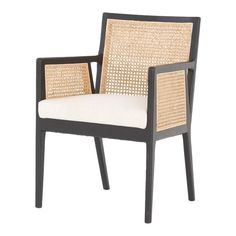 the chair is made out of rattan and has a white seat pad on it