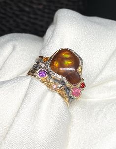 Mexican Fire Agate Gemstone Ring in sterling silver with gold accents size 8 1/2 - 8 3/4 Materials: Silver 925, 24k gold plated, Mexican Fire Agate, Amethyst, Garnet, Pink Tourmaline, Citrine  Face of the ring: Height-15mm,Width-12mm(stone), Band-6mm Please note: Colors may vary slightly due to monitor display settings. Items in the photograph are not actual size. Closeup photos are taken. Please read the measurements. PLEASE READ SHOP ANNOUNCEMENT FOR RETURNS AND EXCHANGES THANK YOU FOR LOOKING Fire Agate, Agate Gemstone, Handmade Artisan, Cleaning Jewelry, Pink Tourmaline, Gold Plated Jewelry, Gemstone Ring, Rings Statement, Gold Accents