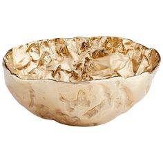 a large metal bowl filled with lots of gold leafy material on top of a white background