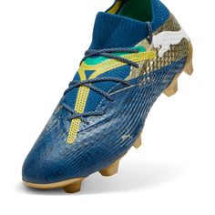 a blue soccer shoe with yellow and green details on the upper part of the shoe