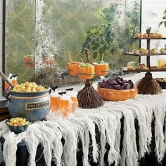 an assortment of halloween treats on display in front of a window with white fringes