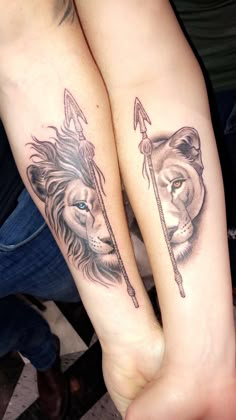 two people with matching tattoos on their arms holding each other's hands, one has an arrow and the other has a lion