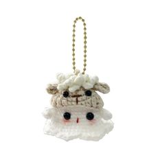 a crocheted sheep ornament hanging from a chain