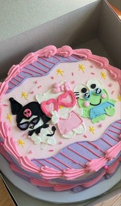 there is a cake in the box that has decorations on it, including cats and dogs