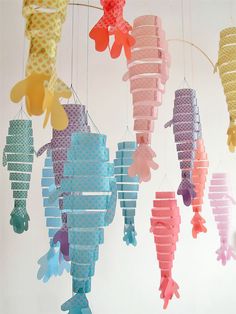 colorful seahorses are hanging from the ceiling in this nursery - style mobile, which is made out of paper