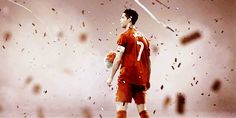 a man in an orange soccer uniform is holding a ball and some confetti