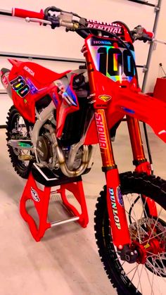 a red dirt bike parked in a garage