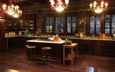 a kitchen with wooden floors and lots of lights