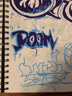 a notebook with graffiti written on it and the word boom in blue ink next to an eyeball