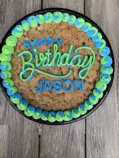 a birthday cake with the words happy birthday mason on it and blue icing in the middle