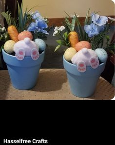 two blue buckets filled with easter decorations