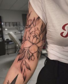 a woman with a flower tattoo on her arm