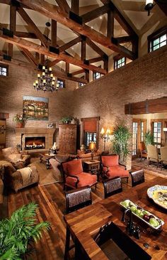 a living room filled with furniture and a fire place in the middle of an open floor plan