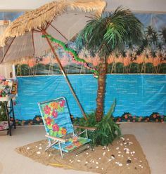 a beach chair under an umbrella in front of a wall with a painting on it