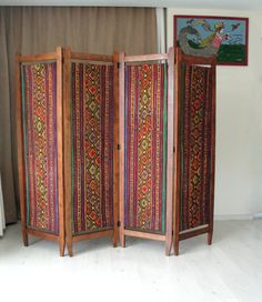 This gorgeous colorful bohemian upholstered wooden room divider would look great anywhere in your living room, office or bedroom. It is entirely made of solid cherry wood and is made in the 1920s or 1930s. PLEASE CONTACT US WITH YOUR LOCATION FOR AN EXACT SHIPPING QUOTE! It has been entirely sanded, stained and oiled. The original fabric was beyond redemption so we replaced it with vintage kilim. Making it a bold, rich, and statement piece of furniture. It would look great in the middle of a roo Room Divider Inspiration, 1920s Room, Privacy Screen Indoor, Fabric Room Divider, Wooden Divider, Privacy Screens Indoor, Room Divider Shelves, Hippie House, Screen Divider