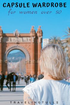 a woman standing in front of an arch with the words capsule wardrobe for women over 50