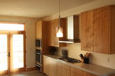 a kitchen with wooden cabinets and stainless steel appliances