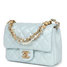 This Chanel mini square pearl Flap Bag is of light blue iridescent lambskin leather with brushed gold tone hardware, has a front flap with signature CC turnlock closure, tonal stitching, rear half moon pocket, a single interwoven light blue leather and brushed gold tone chain link shoulder/crossbody strap and a pearl and chain top handle strap.The Interior is lined in light blue lambskin leather and has one slip pocket on back wall.Collection: 24POrigin: ItalyCondition: New and never worn (plast Powder Blue Handbag, Light Blue Chanel Bag, Chanel Essentials, Chanel Blue Bag, Chanel Bag Collection, Blue Chanel Bag, Channel Purse, Light Blue Purse, Mini Chanel