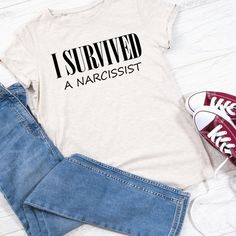 i survived a narcisst t - shirt on a pair of jeans and sneakers