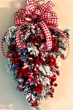 a red and white christmas wreath hanging on the wall