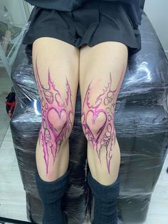 a woman's legs with tattoos on them and her leg in the shape of a heart