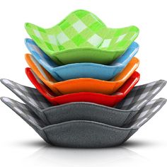 a stack of colorful dishes sitting on top of each other in front of a white background