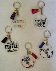 four different key chains with tassels on them, one for coffee and the other for wine