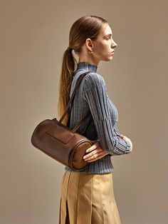 Editor's NotesThis bag from moiqui adds a casual mood to your outlook.- Trapezoid cylindrical silhouette- Thick and soft piping on both sides- Comfortable to wear with the layered shoulder strap- Zipper pocket on the backMeasurements(in.)- Size: 10.24 in. * 5.91 in. * 5.91 in.- Handle Drop: 12.20 in.Composition & Care- Vegan Leather- Avoid direct heat and moisture- In case of contamination, partial washing with neutral detergentDesigner- by moiqui Brown Shoulder Bag With Rolled Handles For Work, Brown Satchel With Rolled Handles, Brown Satchel Bucket Bag With Rolled Handles, Piping, Zipper Pocket, Vegan Leather, Shoulder Strap, Bag Lady, Composition