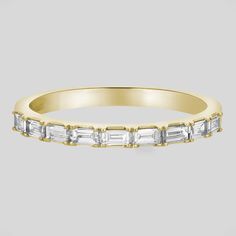 a yellow gold band with baguets and diamonds