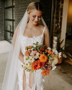 a woman in a wedding dress holding a bouquet