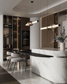 an elegant kitchen with marble counter tops and bar stools, along with modern lighting fixtures