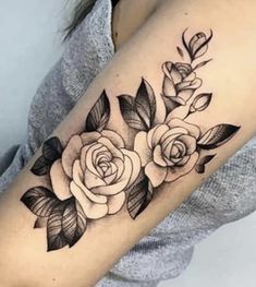 a black and white rose tattoo on the arm