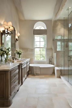 a large bathroom with two sinks and a bathtub next to a walk in shower