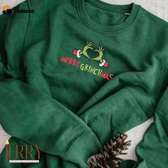 Merry Grinchmas Embroidered Sweatshirt, Grinch Shirt The Grinch Sweatshirt, Embroidered Cotton Christmas Sweatshirt, Embroidered Long Sleeve Christmas Sweatshirt, Casual Christmas Tops With Embroidered Graphics, Christmas Cotton Sweatshirt With Embroidered Logo, Long Sleeve Embroidered Tops For Holiday, Green Embroidered Tops For Winter, Holiday Cotton Top With Embroidery, Holiday Cotton Embroidered Tops