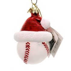 a baseball ornament with a santa hat on it