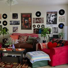 a living room filled with furniture and pictures on the wall