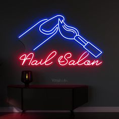 a neon sign that says nail salon with a hair dryer in the corner next to it