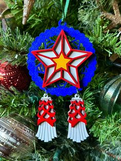 an ornament hanging from a christmas tree decorated with red, white and blue decorations