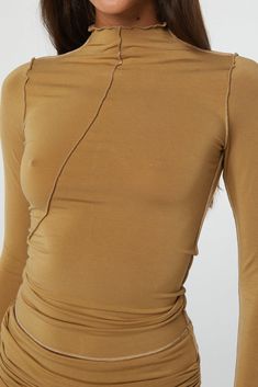 Elastane Long Sleeve Top For Layering, Solid Asymmetrical Hem Top For Layering, Chic Tops With Thumbholes And Minimal Stretch, Chic Fitted Top With Thumbholes, Chic Fitted Tops With Thumbholes, Asymmetrical Fitted Elastane Top, Versatile Second-skin Tops For Spring, Fitted Top With Asymmetrical Neckline For Workwear, Spring Tops With Thumbholes And Minimal Stretch