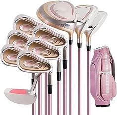 a set of golf clubs with pink accessories