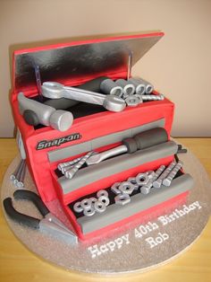 a birthday cake made to look like a toolbox with wrenches and screws