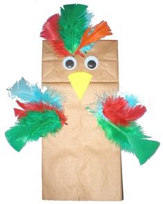 a paper bag with a bird made out of feathers on it's face and eyes