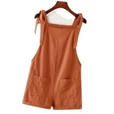 Adorable Tie Knot Strap Overall Shorts Pocket Jumpsuit In Rust Brown Fabric: 100% Cotton Design: Tie Knot Strap/ Double Pocket Front/ Roll Up Hem Small: Size 4 Length:31.1 Inch, Bust:35 Inch, Waist Size:35.8 Inch, Hip Size:4 0.9 Inch, Thigh:27.2 Inch, Straps Length:25.6 Inch Medium: Size 6 Length:31.6 Inch, Bust:36.6 Inch, Waist Size:37.4 Inch, Hip Siz E:42.5 Inch, Thigh:28 Inch, Straps Length:25.8 Inch Large: Size 8/10 Length:32.3 Inch, Bust:39 Inch, Waist Size:39.8 Inch, Hip Size:4 4.9 Inch, T Solid Overalls With Pockets For Vacation, Summer Cotton Shortalls Overall, Cotton Overalls With Tie Straps, Summer Overalls With Pockets, Summer Jumpsuits And Rompers With Pockets, Cotton Summer Shortalls For Spring, Sleeveless Summer Shortalls With Pockets, Spring Beach Jumpsuits And Rompers With Suspenders, Vacation Overalls With Pockets