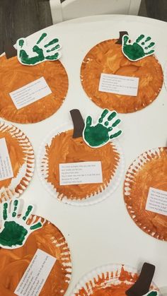 paper plates with handprints on them sitting on a table